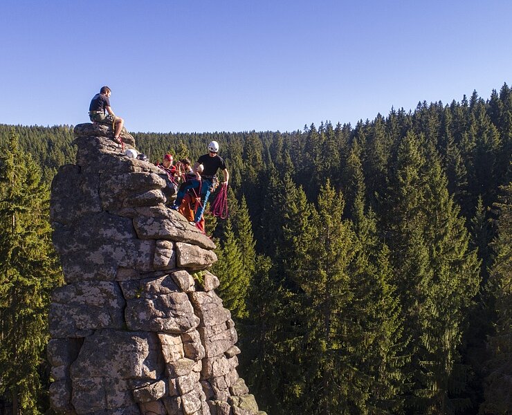 Kletterer genießen den Ausblick über die Wälder des Erzgebirges (Tourist-Information Johanngeorgenstadt)